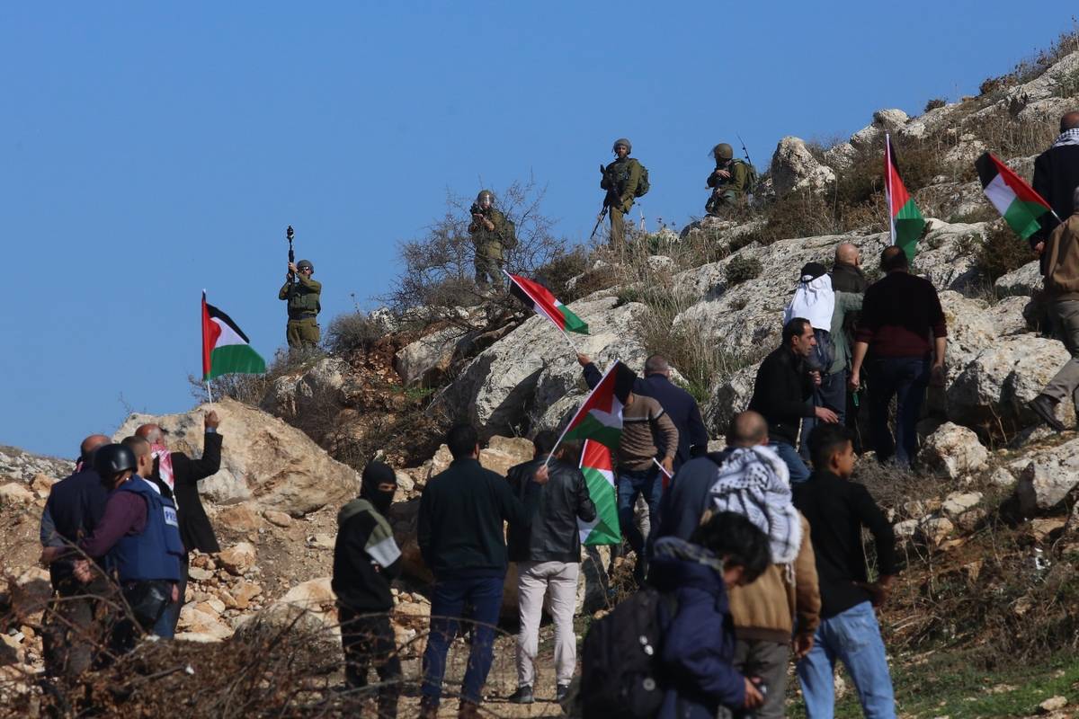 Palestinians gather in the Beit Dajan village of Nablus, to stage a demonstration against the construction of Jewish settlements in the region, in West Bank on December 16, 2022. ( Nedal Eshtayah - Anadolu Agency]