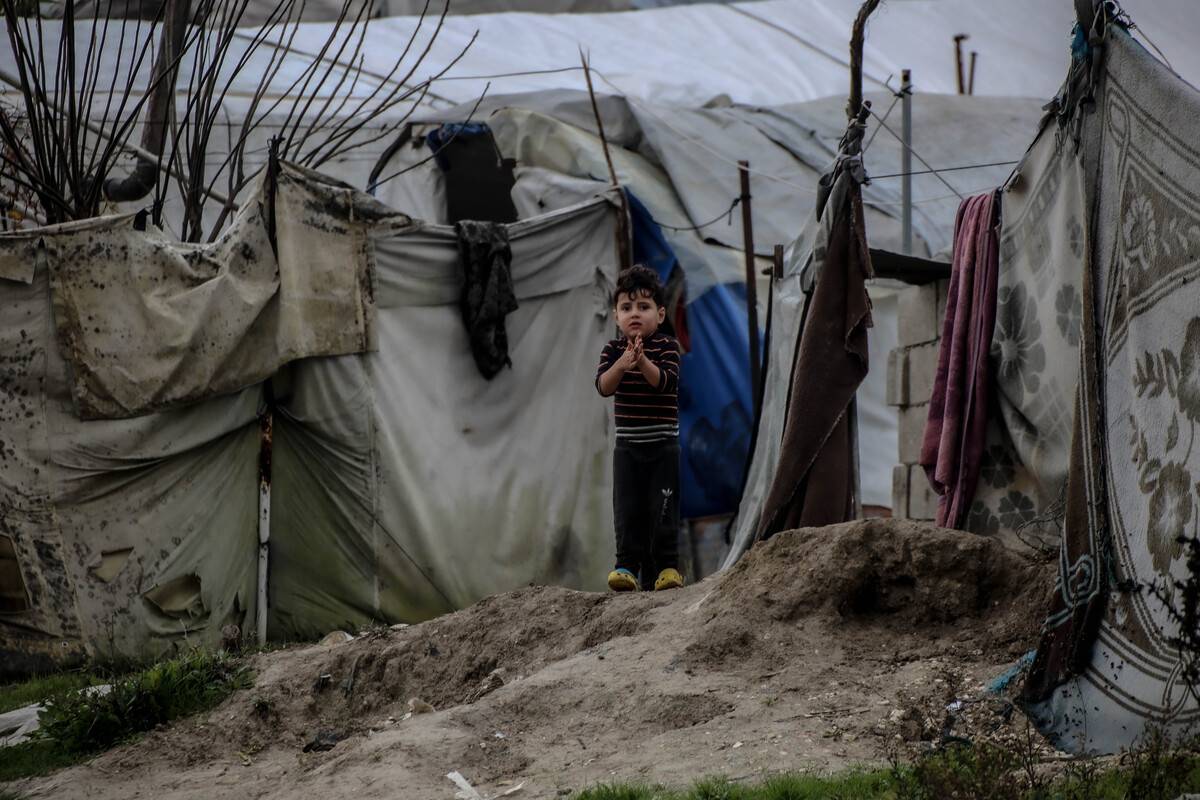 A child is seen in front of makeshift tent at Ataa Refugee Camp, Syria on December 25, 2022. [İzzeddin Kasim - Anadolu Agency]