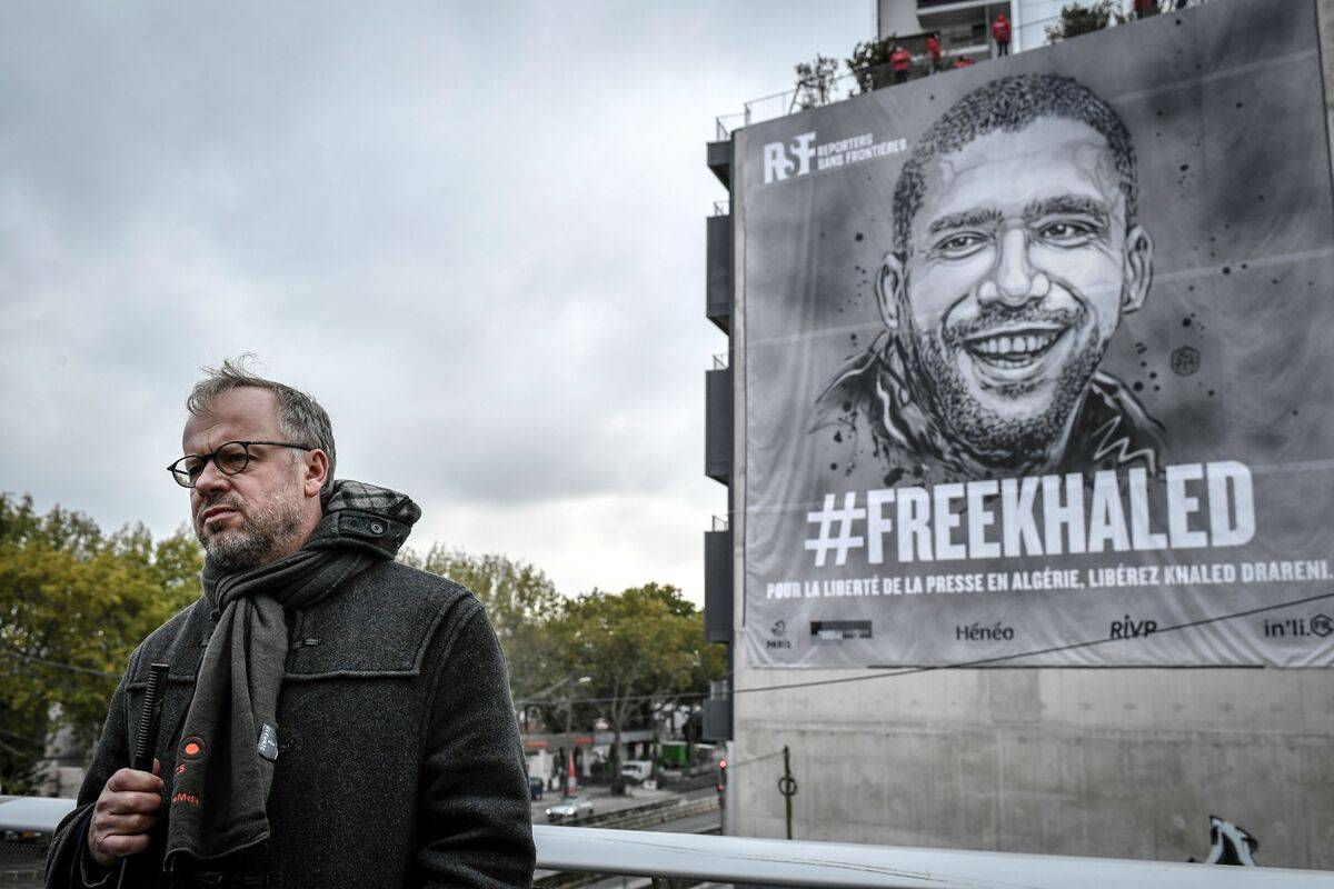 Secretary general of International press freedom watchdog Reporters sans frontieres (RSF- Reporters Without Borders) Christophe Deloire delivers a speech during the installation of a tarp depecting jailed Algerian journalist Khaled Drareni by French street-artist C215 [STEPHANE DE SAKUTIN/AFP via Getty Images]