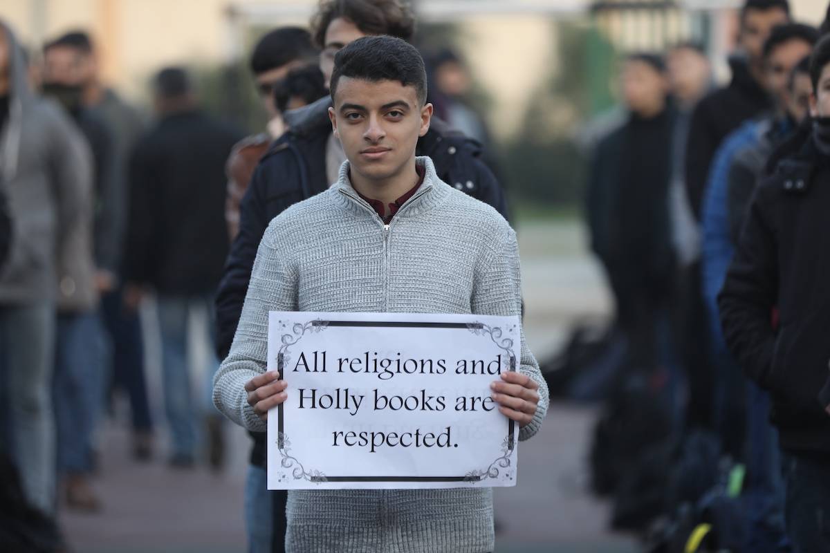 Students stage a protest against the burning of the Quran in Sweden on 24 January 2023, in Gaza [Mohammed Asad/Middle East Monitor]