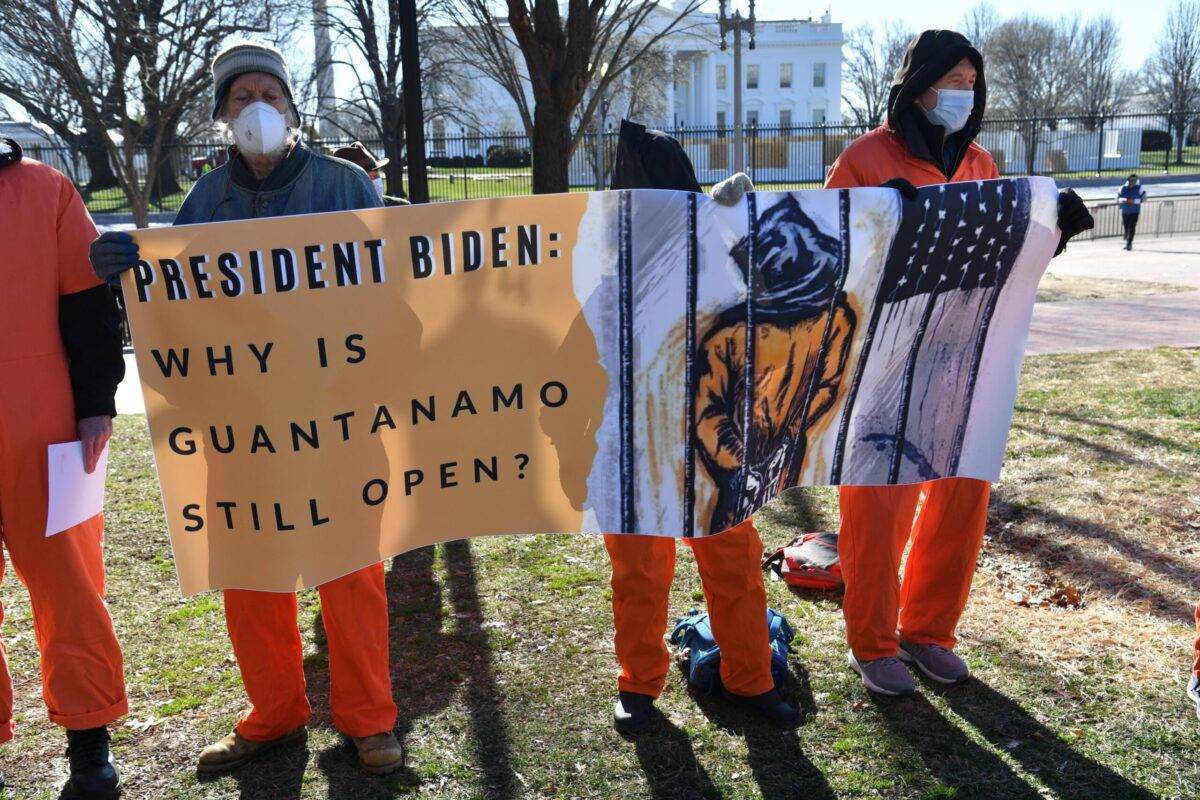 Demonstrators hold a sign during a protest calling for the closure of Guantanamo in front of the White House in Washington, DC on January 11, 2022 [NICHOLAS KAMM/AFP via Getty Images]