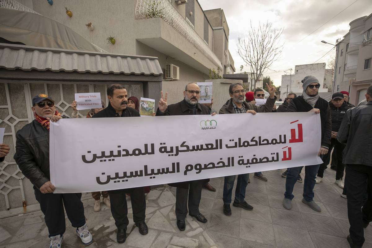 Demonstrators holding placards and banners gather to show their support for lawyer and former Member of Parliament (MP) Seif Eddine Makhlouf, who was tried and sentenced in a military court outside the Military Court in Tunis, Tunisia on February 03, 2023 [Yassine Gaidi/Anadolu Agency]