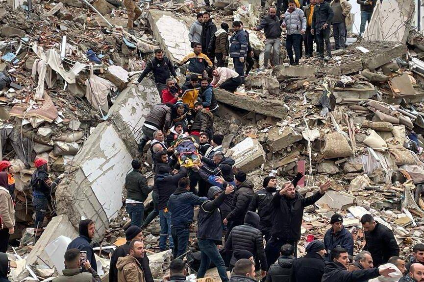 A person is rescued from the wreckage of a building during search and rescue efforts after a 7.4 magnitude earthquake hit southern provinces of Turkiye, in Adana, Turkiye on February 6, 2023. [Eren Bozkurt - Anadolu Agency ]