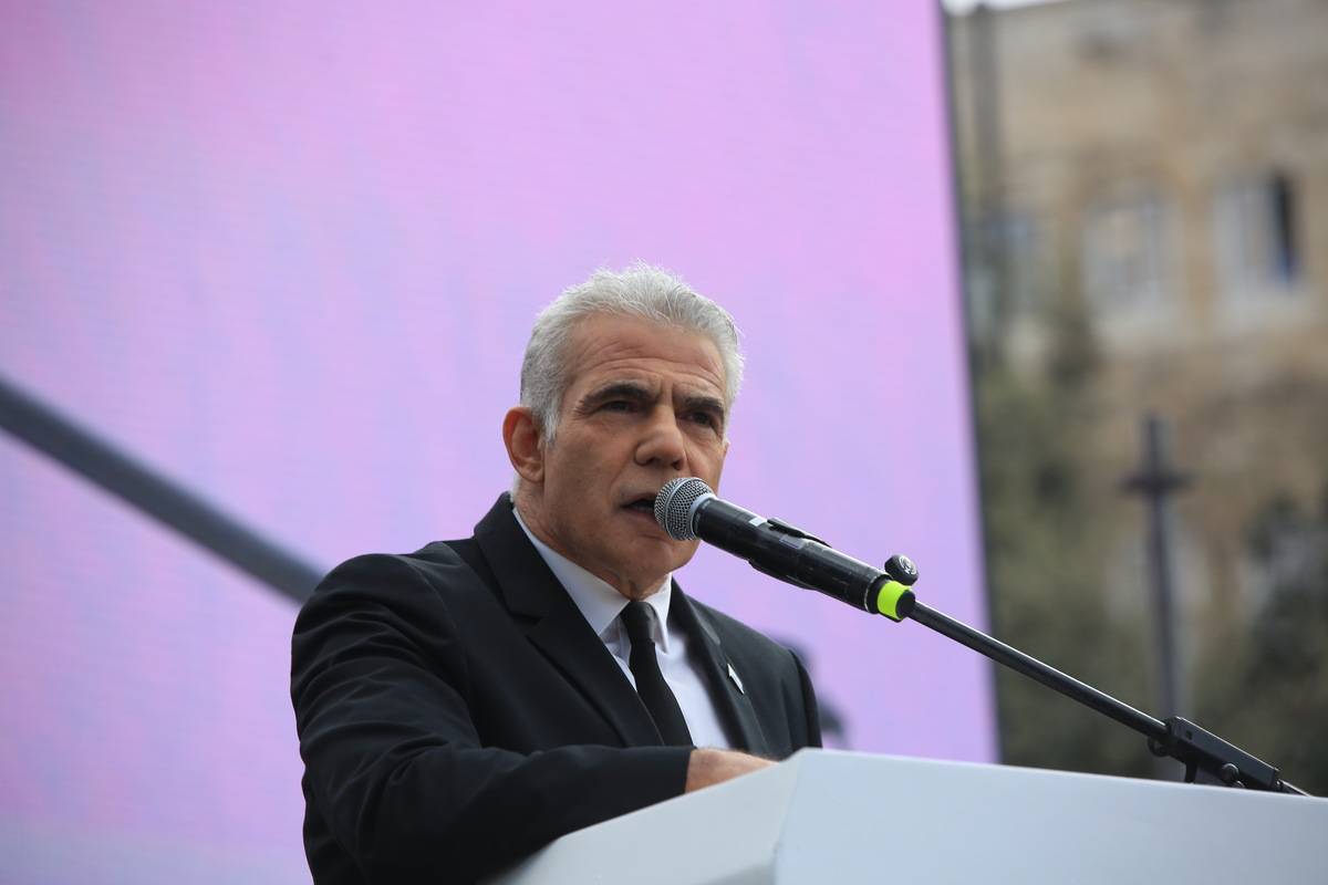 Leader of the Opposition Yair Lapid speaks as Israeli people gather in front of parliament to protest against judicial reform plans during a preliminary vote in Jerusalem on February 13, 2023 [Saeed Qaq - Anadolu Agency]