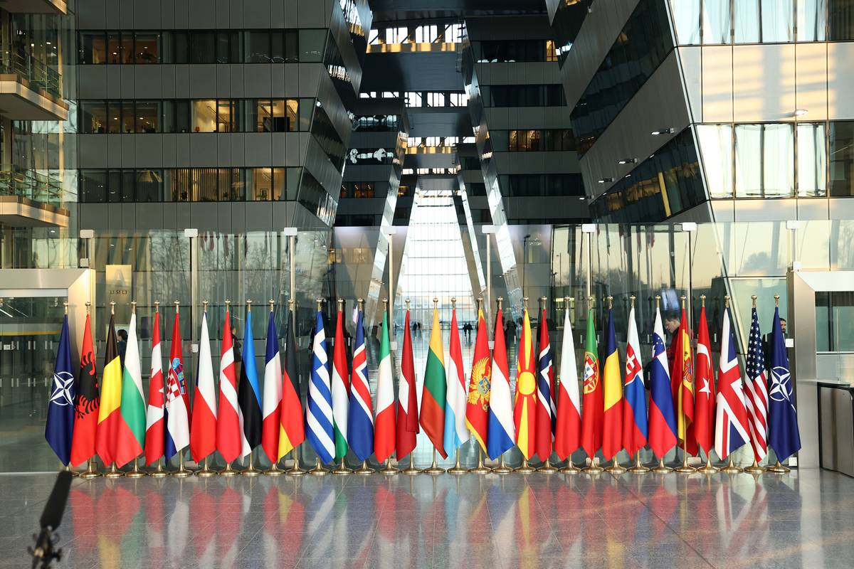 Member country flags are placed on the first day of the NATO Defence Ministers' Meeting in Brussels, Belgium. [Dursun Aydemir - Anadolu Agency]