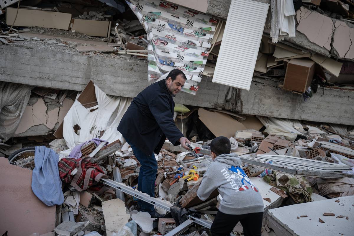 Victims search for their belongings in the debris of their home after powerful quakes hit Onikisubat