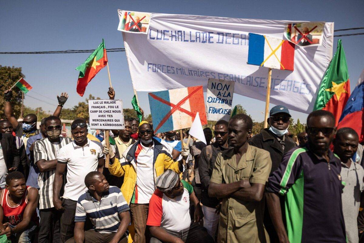 Demonstrators hold placards during a protest to support the Burkina Faso President Captain Ibrahim Traore and to demand the departure of France's ambassador and military forces, in Ouagadougou, on January 20, 2023. [OLYMPIA DE MAISMONT/AFP via Getty Images]