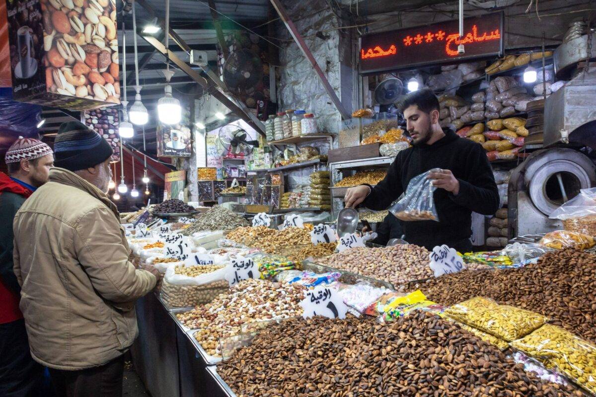 A man sells nuts on a stall on traditional Arab souk in Amman, capital of Jordan on January 12, 2023 [Dominika Zarzycka/NurPhoto via Getty Images]