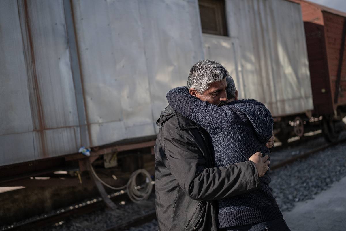 49-year-old operator Ahmet Turan Akbas is seen as he takes solace with his son rescued under the rubble [Özge Elif Kızıl / Anadolu Agency]