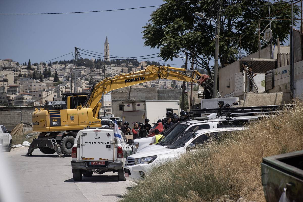 Israeli forces take precautions as they arrive to demolish the business of the Palestinian Al-Abbasi family on the grounds that it was unlicensed in Silvan town of Eastern Jerusalem on May 10, 2023 [Mostafa Alkharouf - Anadolu Agency]