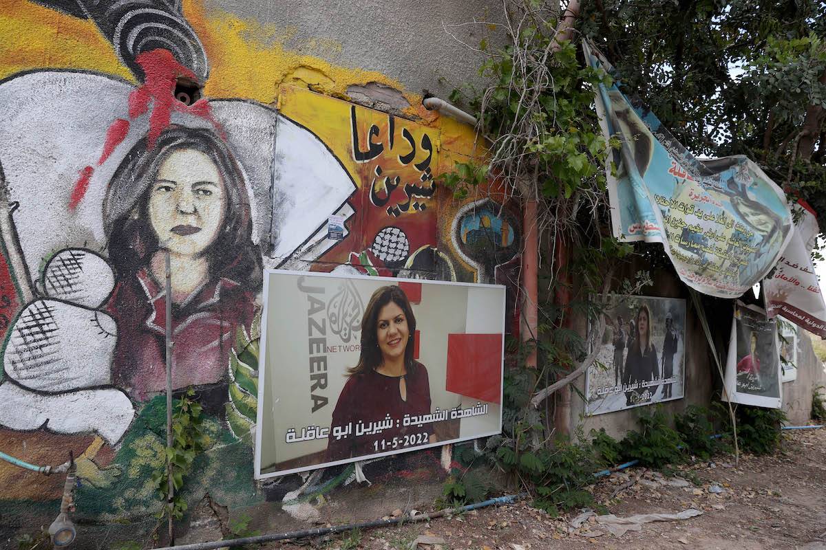 Murals and posters with the portrait of Shireen Abu Akleh, Al Jazeera's reporter who has been killed by Israeli forces last year, are seen at the area where her death occurred in Jenin, West Bank on April 30, 2023 [Issam Rimawi - Anadolu Agency]