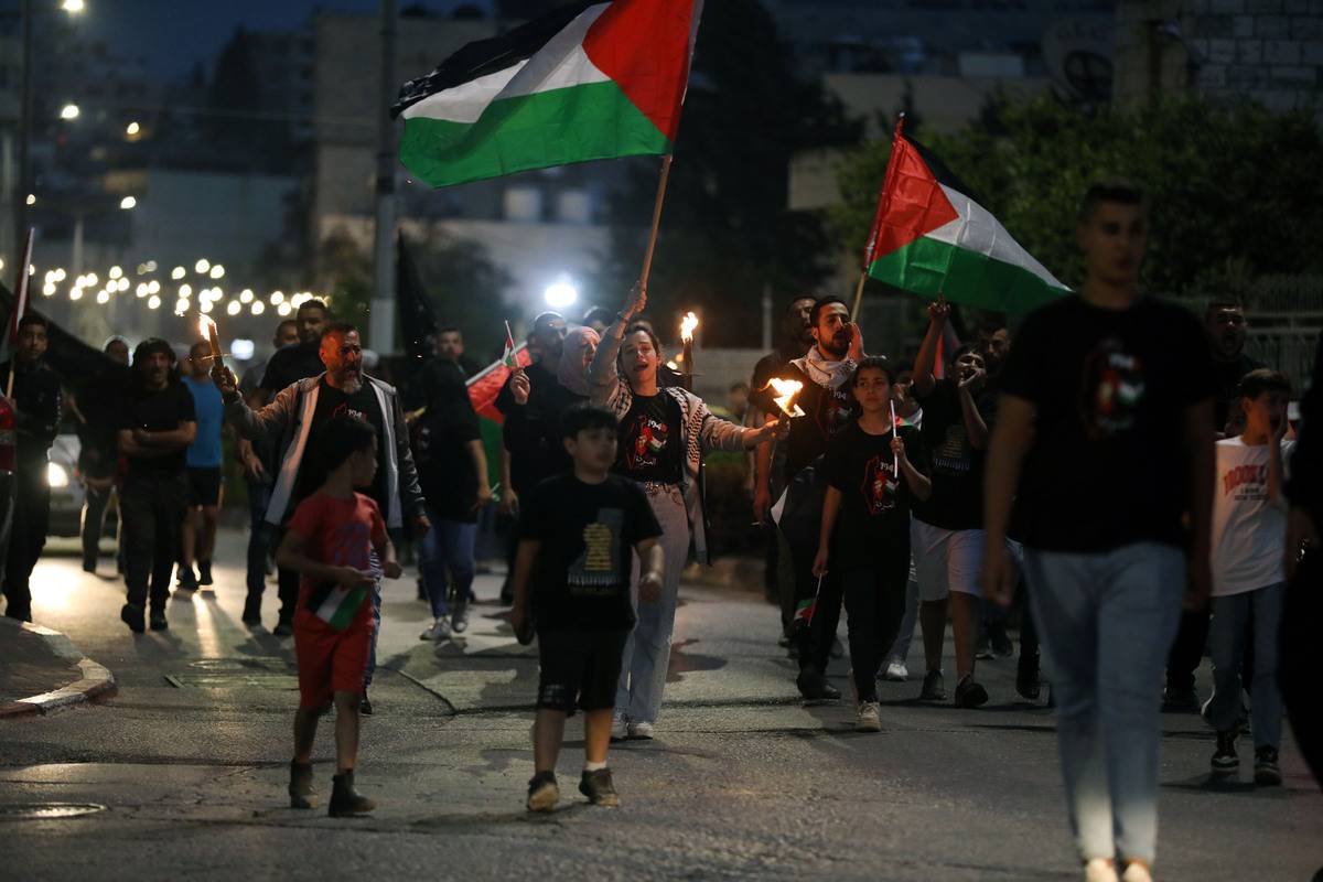 Palestinians march with torches on the 75th anniversary of Israel's declaration of independence, which Palestinians call the Great Catastrophe (Nakba), and its forced migration of Palestinians on Bethlehem, West Bank on May 14, 2023 [Wisam Hashlamoun/Anadolu Agency]