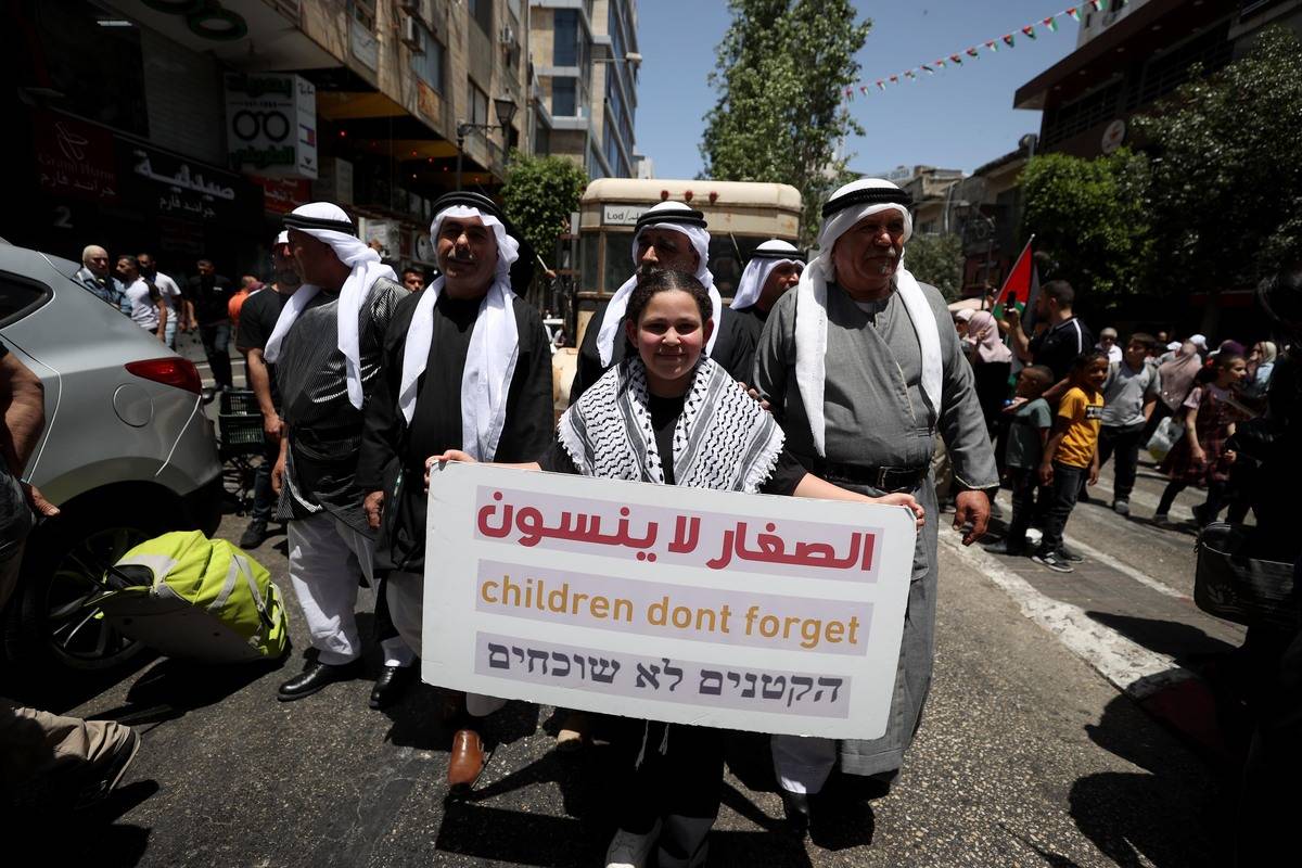 Palestinians march with banners on the 75th anniversary of Israel's declaration of independence, which Palestinians call the Great Catastrophe (Nakba), and its forced migration of Palestinians in Ramallah, West Bank on May 15, 2023. [ Issam Rimawi - Anadolu Agency]