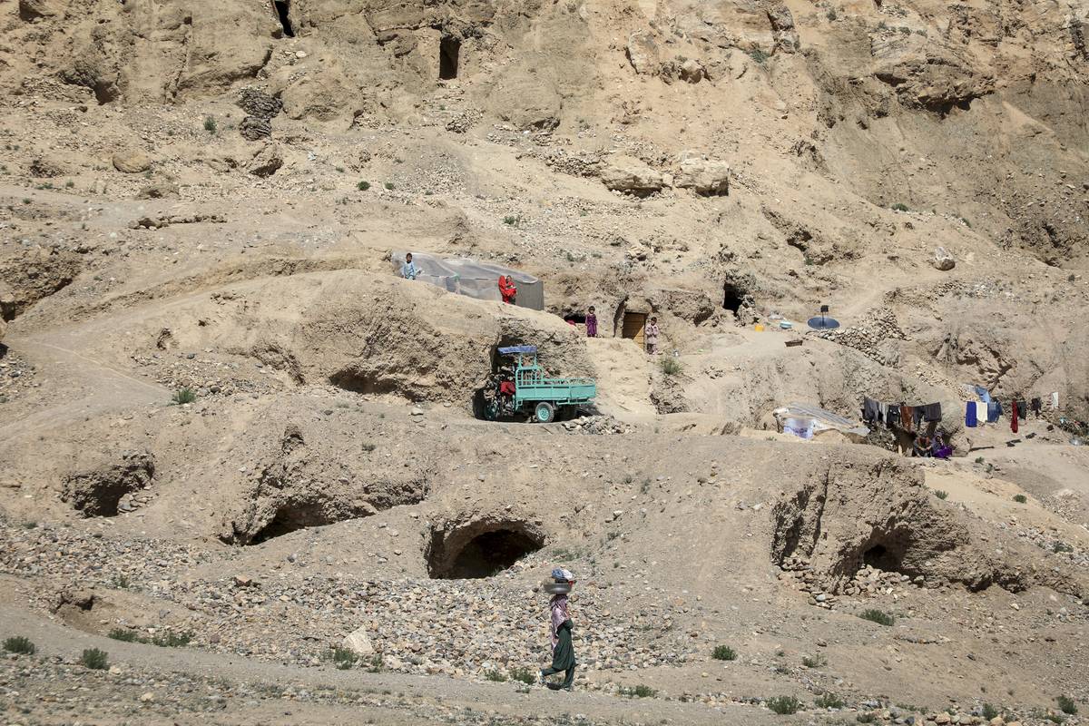 A general view of the caves inhabited by Afghan families, while many people struggle with drought, hunger, disease and malnutrition in Bamyan Province, Afghanistan on May 8, 2023 [Sayed Khodaiberdi Sadat - Anadolu Agency]