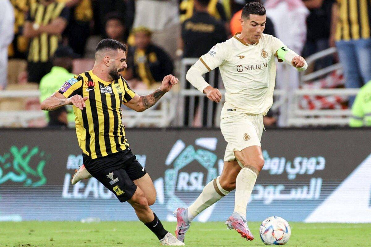 Ittihad's Brazilian midfielder Bruno Henrique (L) vies for the ball against Nassr's Portuguese forward Cristiano Ronaldo during the Saudi Pro League football match between al-Ittihad and al-Nassr at King Abdullah Sport City Stadium in Jeddah on March 9, 2023 [AFP via Getty Images]