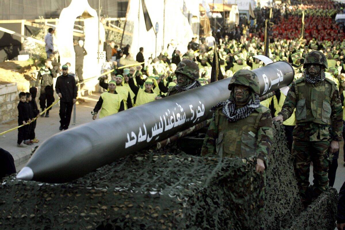 Soldiers ride on a vehicle carrying a Fajr 5 missile on November 28, 2012 [MAHMOUD ZAYYAT/AFP via Getty Images]