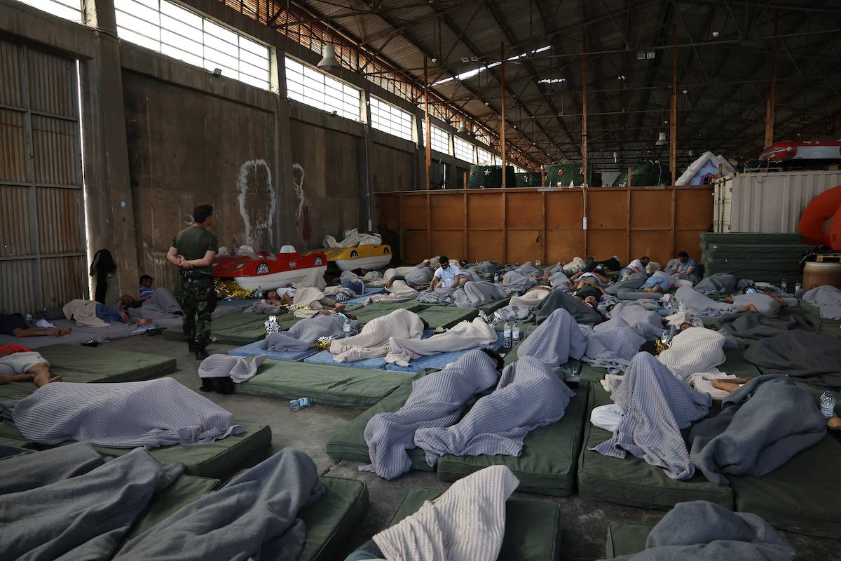 Rescued migrants find shelter at a depot, following a shipwreck off shore in Kalamata , Greece on June 14, 2023 [Costas Baltas - Anadolu Agency]