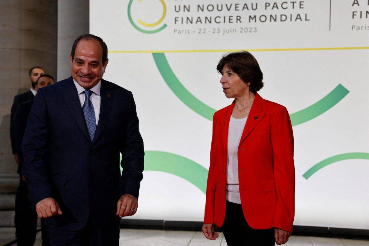 Egypt's President Abdel Fattah al-Sisi (L) and France's Foreign Minister Catherine Colonna greet each other as they arrive at the Palais Brongniart for the New Global Financial Pact Summit in Paris on June 22, 2023 [LUDOVIC MARIN/POOL/AFP via Getty Images]