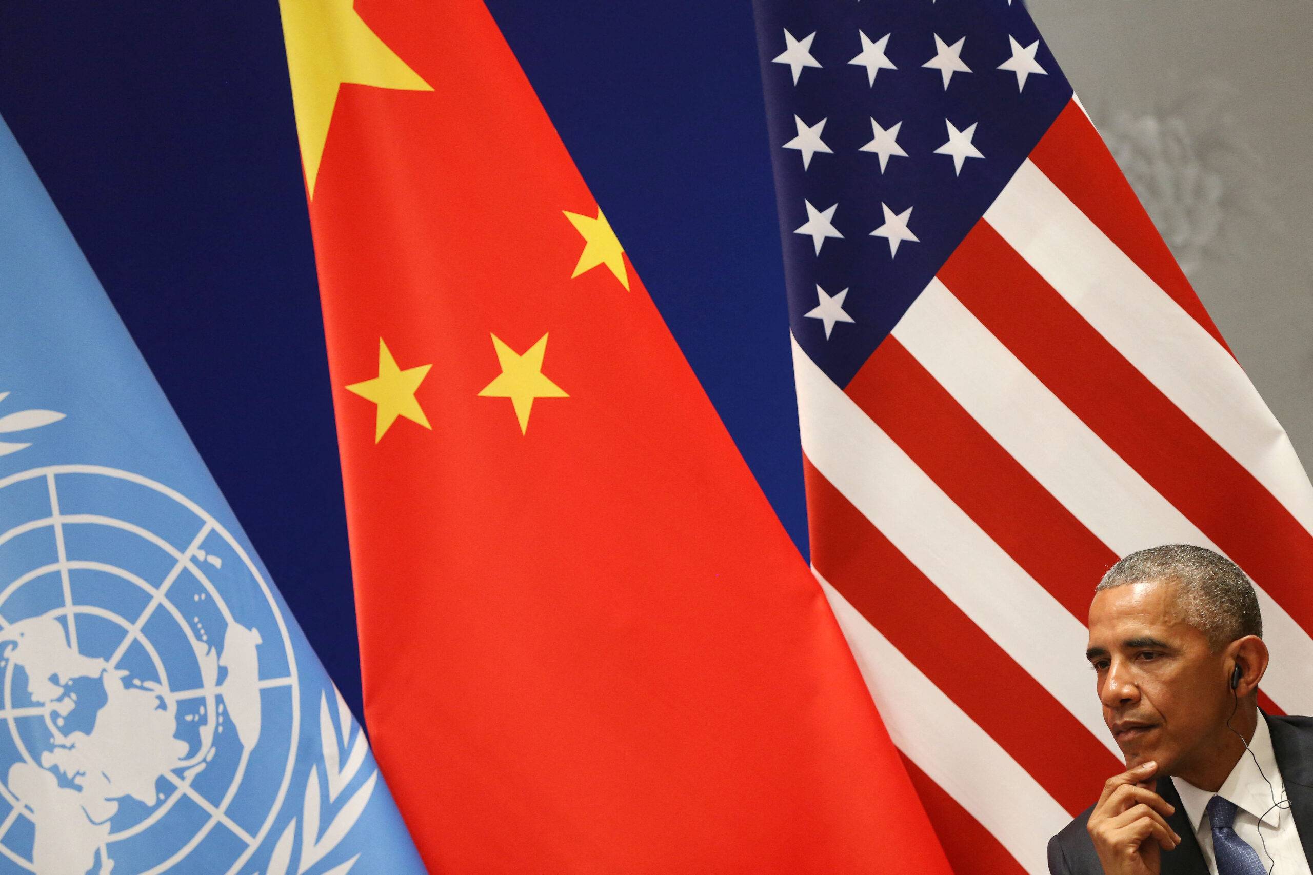 44th US President Barack Obama listens during a joint ratification of the Paris climate change agreement with Chinese President Xi Jinping (not pictured) ahead of the G20 Summit at the West lake State Guest House in Hangzhou on September 3, 2016 [HOW HWEE YOUNG/POOL/AFP via Getty Images]