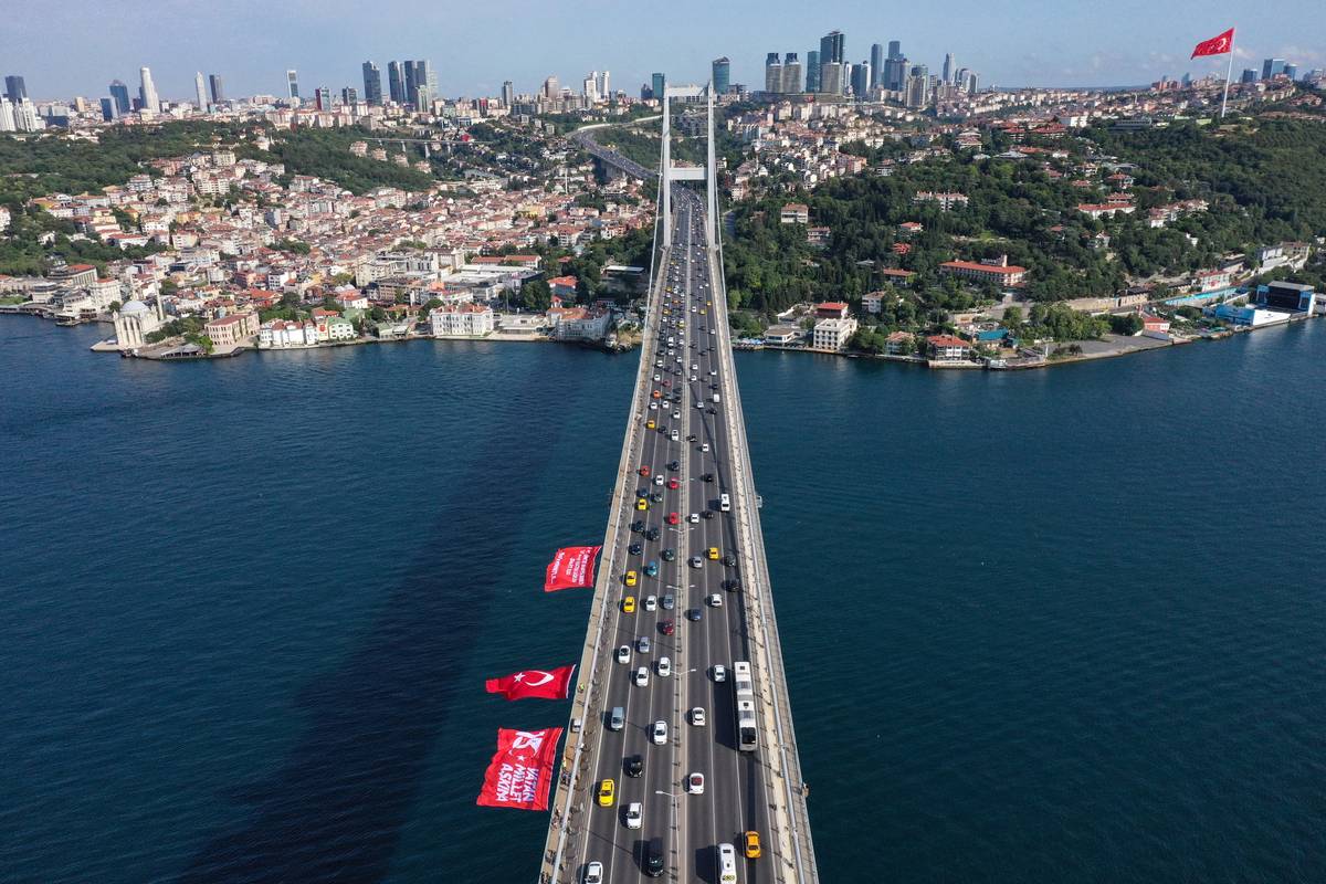 An aerial view of the Turkish flag and banners hung on the 15 July Martyrs Bridge in Istanbul, Turkiye on July 15, 2023 [Ali Atmaca - Anadolu Agency]