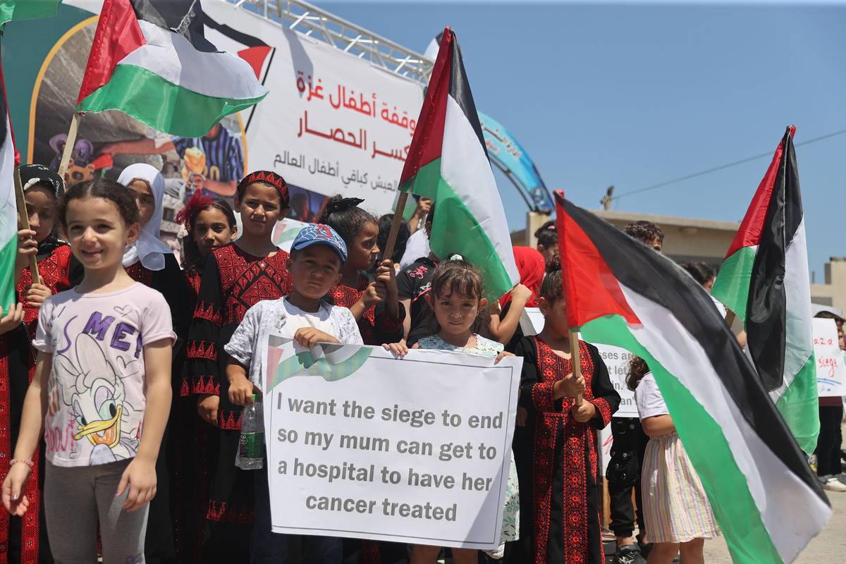 A group of Palestinian children carrying banners gather to protest Israel's policies and demand an end to the blockade on the Gaza Strip since 2006 in Gaza City, Gaza on July 16, 2023 [Mustafa Hassona - Anadolu Agency]