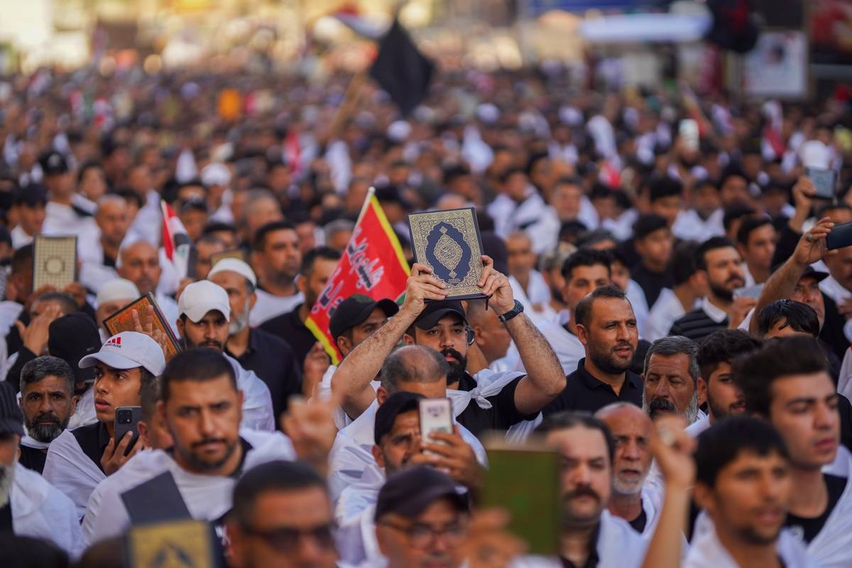 Supporters of Sadrist Movement gather with the call of the Sadrist Movement leader Muqtada al-Sadr to protest against Quran burning in Sweden and Denmark on the road between the tombs of Imam Hussain (Husayn Ibn Ali) and Abbas ibn Ali in Karbala, Iraq on July 28, 2023 [Karar Essa - Anadolu Agency]