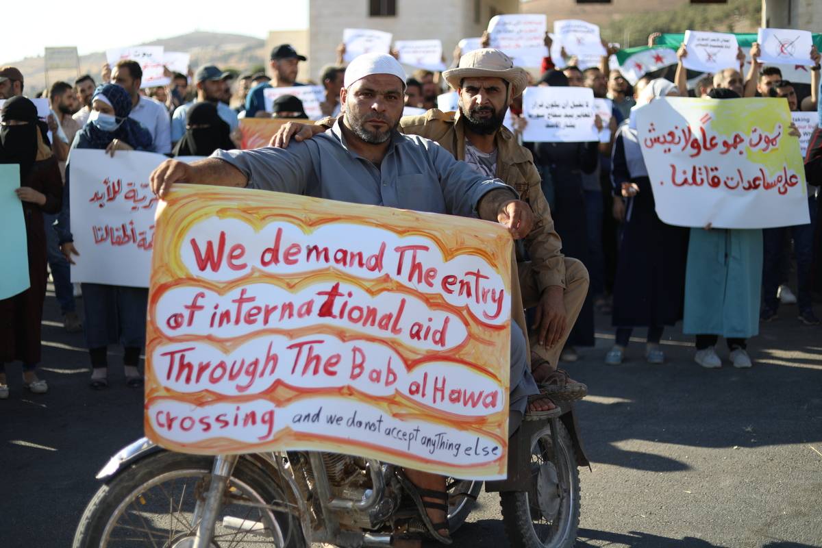 People protest against the blocking of humanitarian aid due to Russia's veto at Bab al-Hawa Border Crossing in Idlib, Syria on August 2, 2023 [İzettin Kasım/Anadolu Agency]