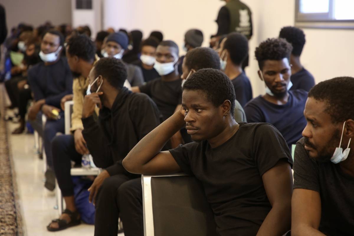 161 African irregular migrants, sent back to their country as a part of return program jointly organized by Libyan authorities and the United Nations (UN) and International Organization for Migration (IOM), wait at the removal centre before departing in Tripoli, Libya on August 21, 2023. [Hazem Turkia - Anadolu Agency]