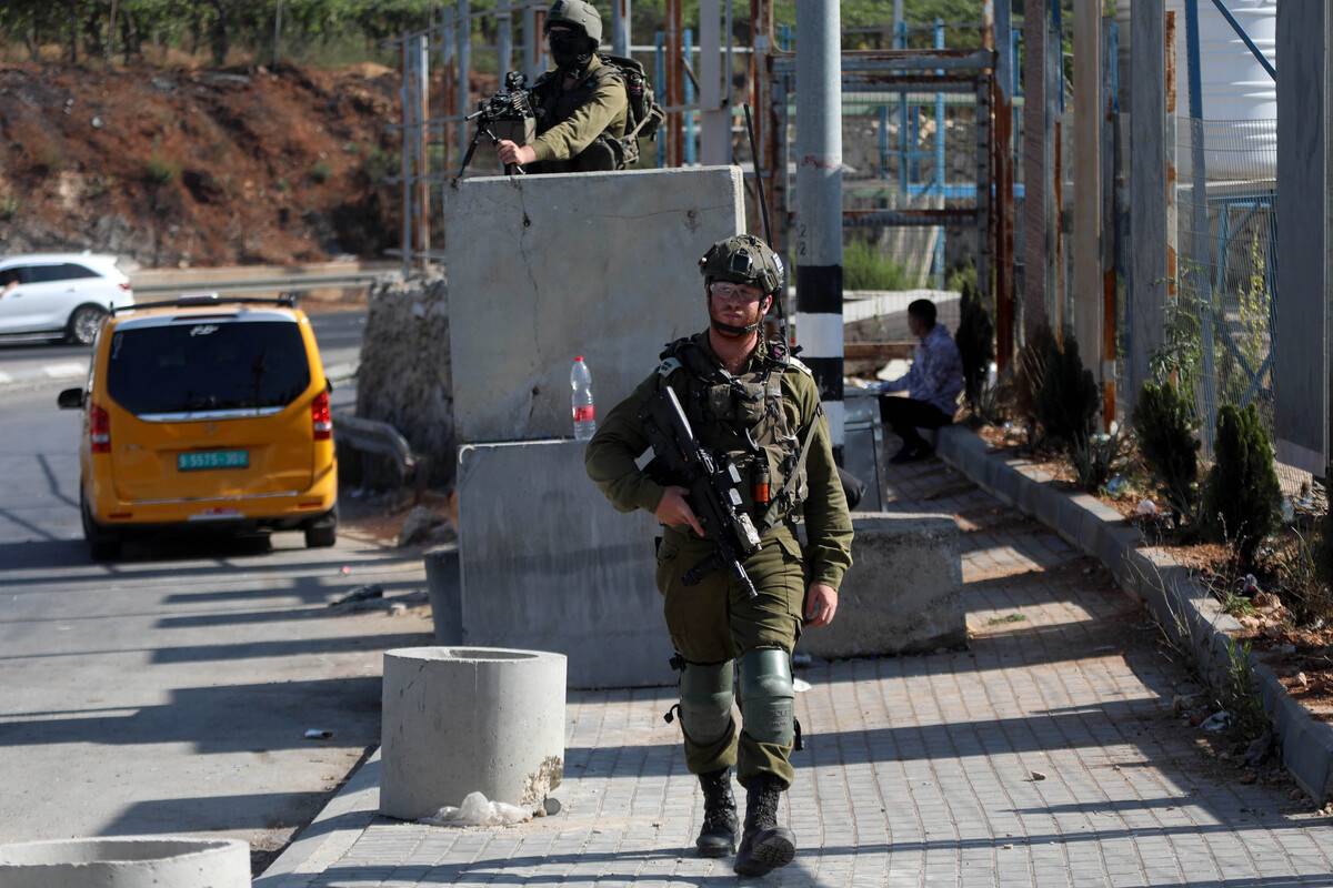 Israeli soldiers are seen at check point as close all entrances and exits to Al Khalil, in Hebron, Occupied West Bank on August 22, 2023 [Mamoun Wazwaz/Anadolu Agency]