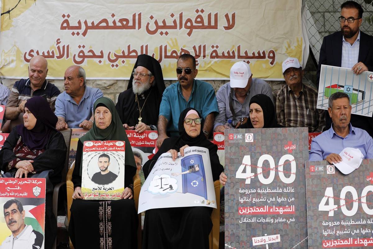 Palestinians, holding banners, gather to stage a demonstration on demanding the delivery of the funeral of relatives and release of the Palestinian prisoners at International Committee of the Red Cross (ICRC) building in Ramallah, West Bank on August 28, 2023. [Issam Rimawi - Anadolu Agency]