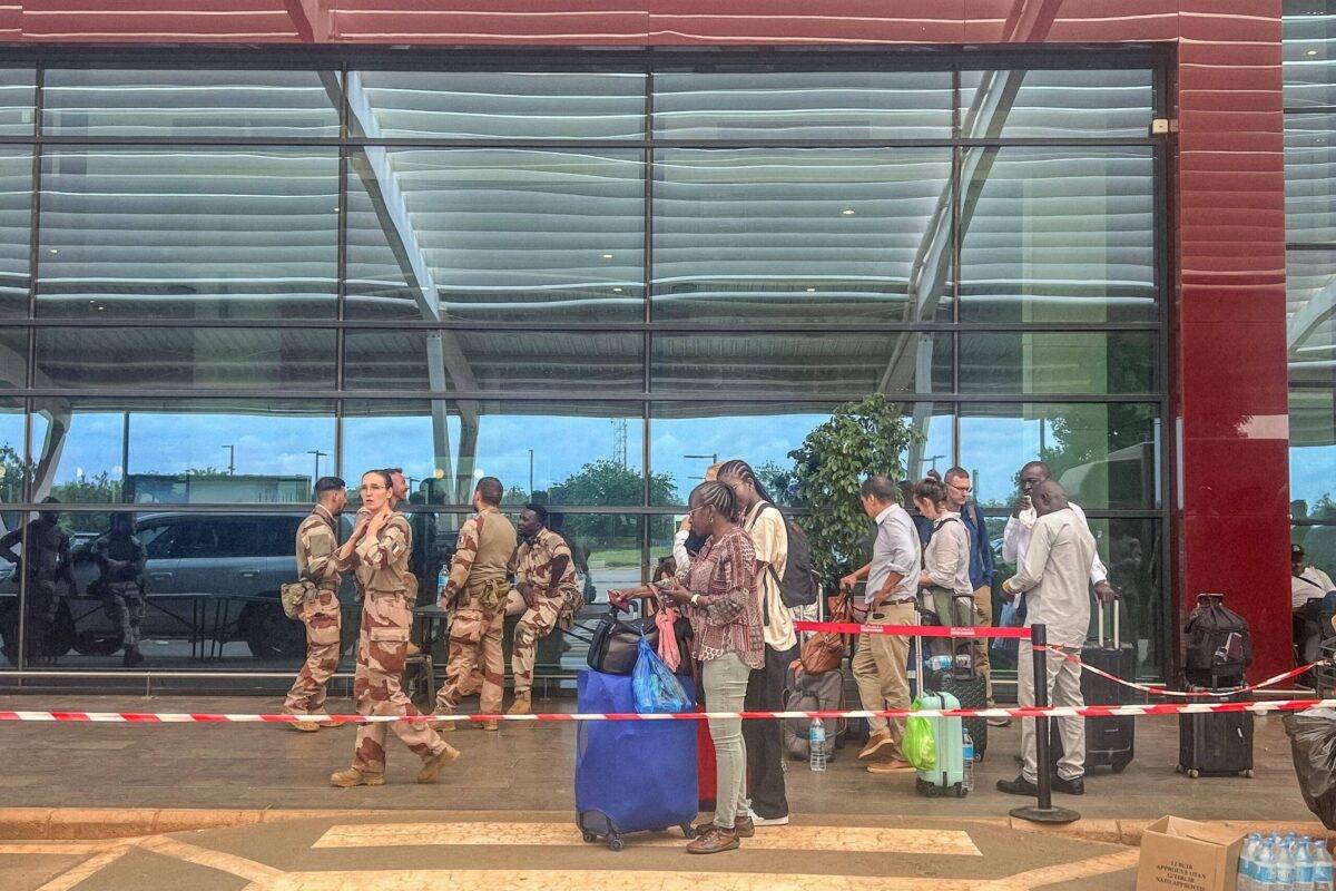 French soldiers and citizens of European countries are seen outside the Diori Hamani International Airport in Niamey on August 2, 2023 [STANISLAS POYET/AFP via Getty Images]