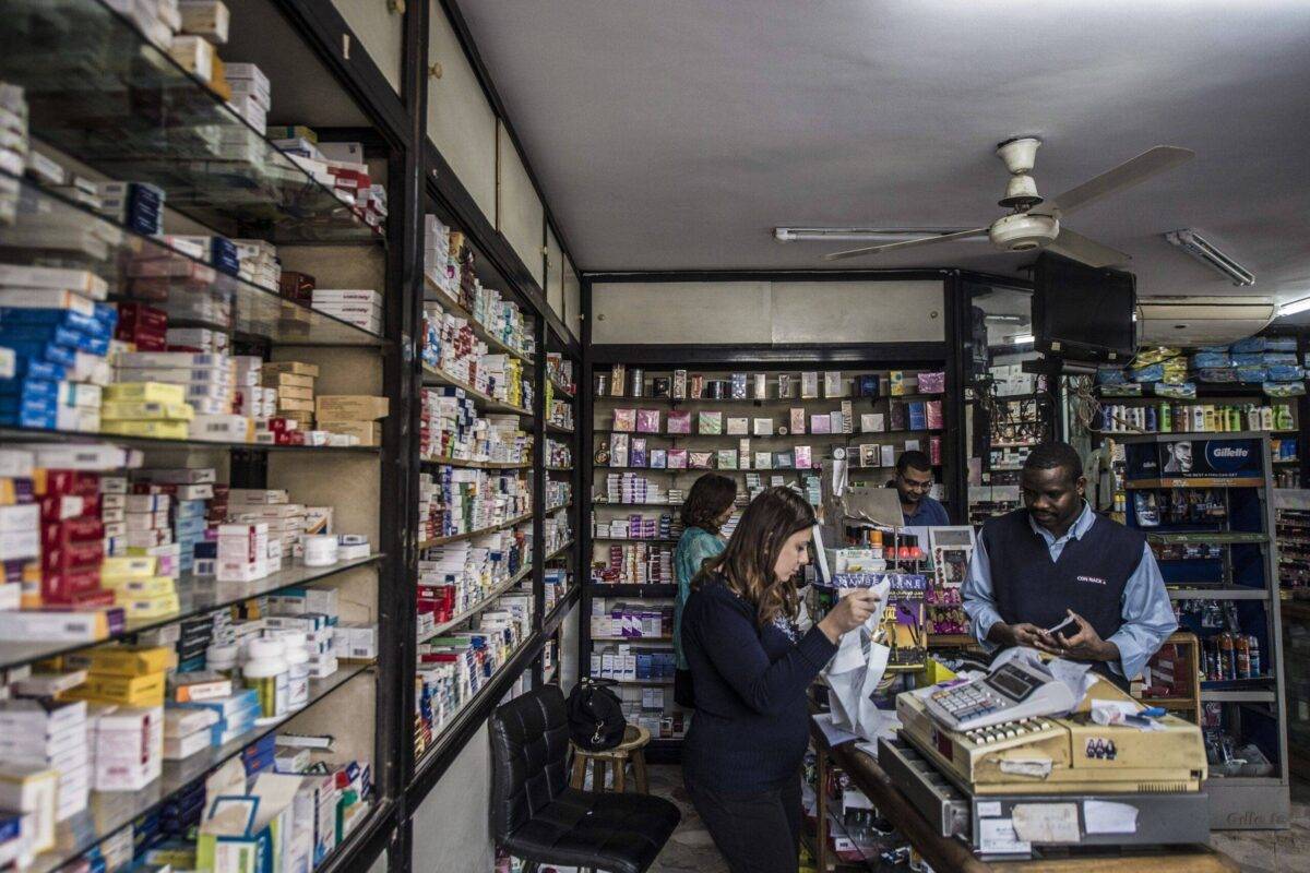 An Egyptian pharmacy employee sells medicine to a customer in a pharmacy in the capital Cairo on November 9, 2016 [KHALED DESOUKI/AFP via Getty Images]