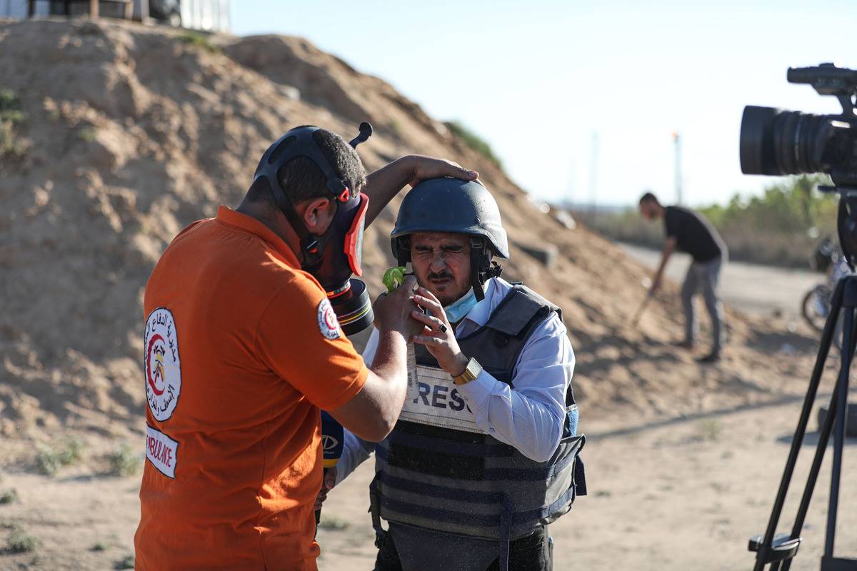 Paramedics treat Palestinian journalists affected by tear gas during a protest against the Jewish raid on Al-Aqsa Mosque in Gaza City, Gaza on September 17, 2023 [Mustafa Hassona/Anadolu Agency]