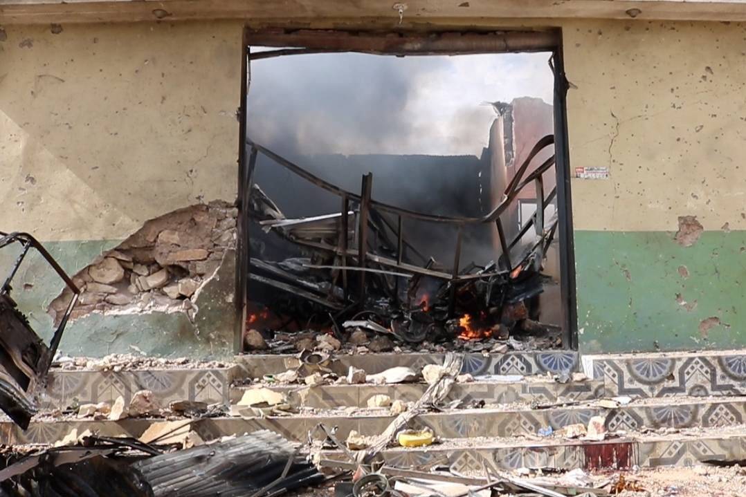 A view of the damaged building as people inspect the area after car bomb attack occured in Beledweyne, Somalia on September 23, 2023 [Abuukar Mohamed Muhidin/Anadolu Agency]