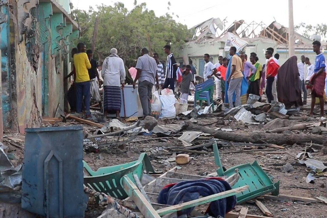 A view of the damaged building as people inspect the area after car bomb attack occured in Beledweyne, Somalia on September 23, 2023 [Abuukar Mohamed Muhidin/Anadolu Agency]