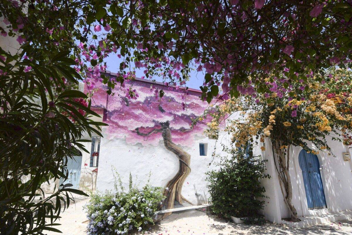A mural painting covers a wall in the town of Hara Sghira on the Tunisian resort island of Djerba on May 19, 2022 [FETHI BELAID/AFP via Getty Images]