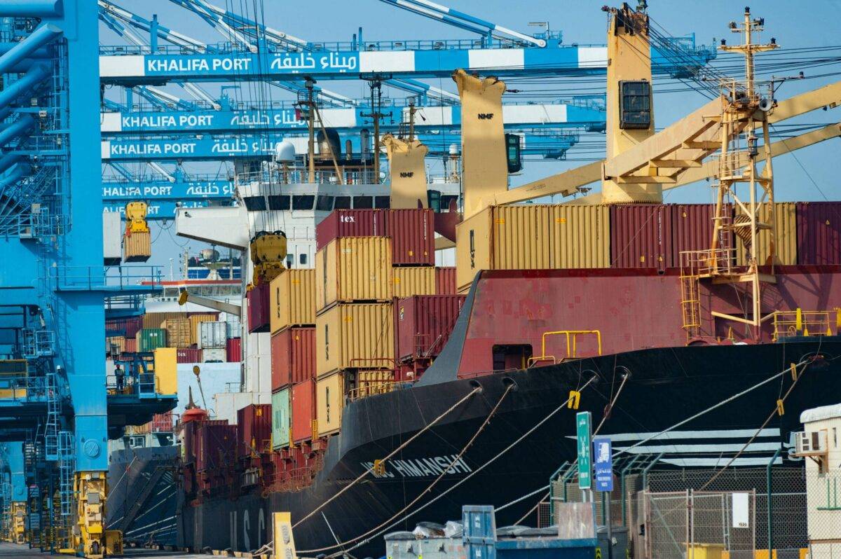 Shipping containers are being unloaded from a container ship at Khalifa Port, UAE [John Wreford/SOPA Images/LightRocket via Getty Images]