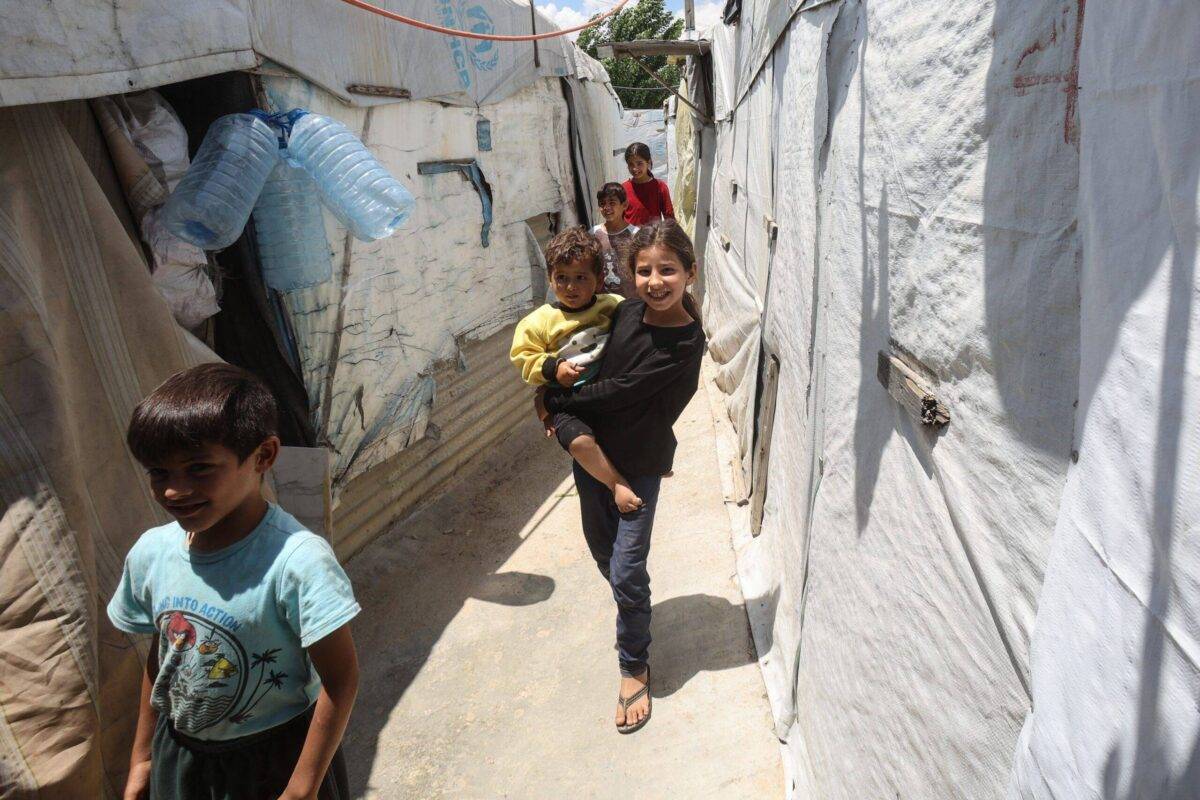 Syrian children walk between tents at a refugee camp in Saadnayel in eastern Lebanon's Bekaa Valley on 13 June, 2023 [ANWAR AMRO/AFP via Getty Images]