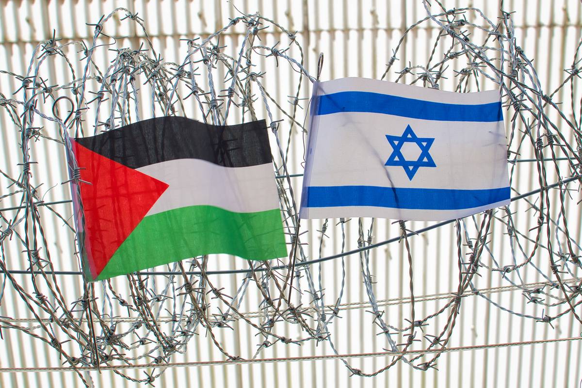 Palestine and Israel flag on barbed wire. [Stock photo via Getty Images]