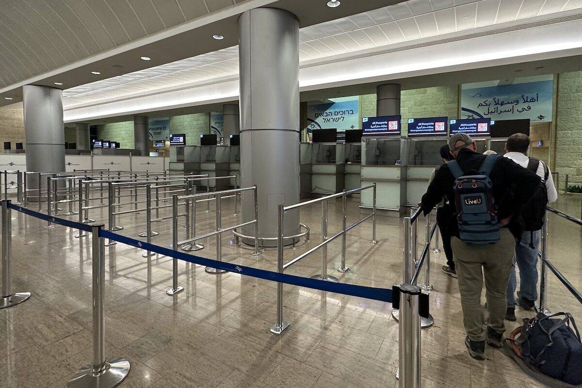 A few people line up in the passport section for international arrivals at empty Ben Gurion Airport, Israel's only international airport, after many flights from abroad are cancelled due to the attacks launched by Palestinian factions in Tel Aviv, Israel on October 8, 2023. [Turgut Alp Boyraz - Anadolu Agency]