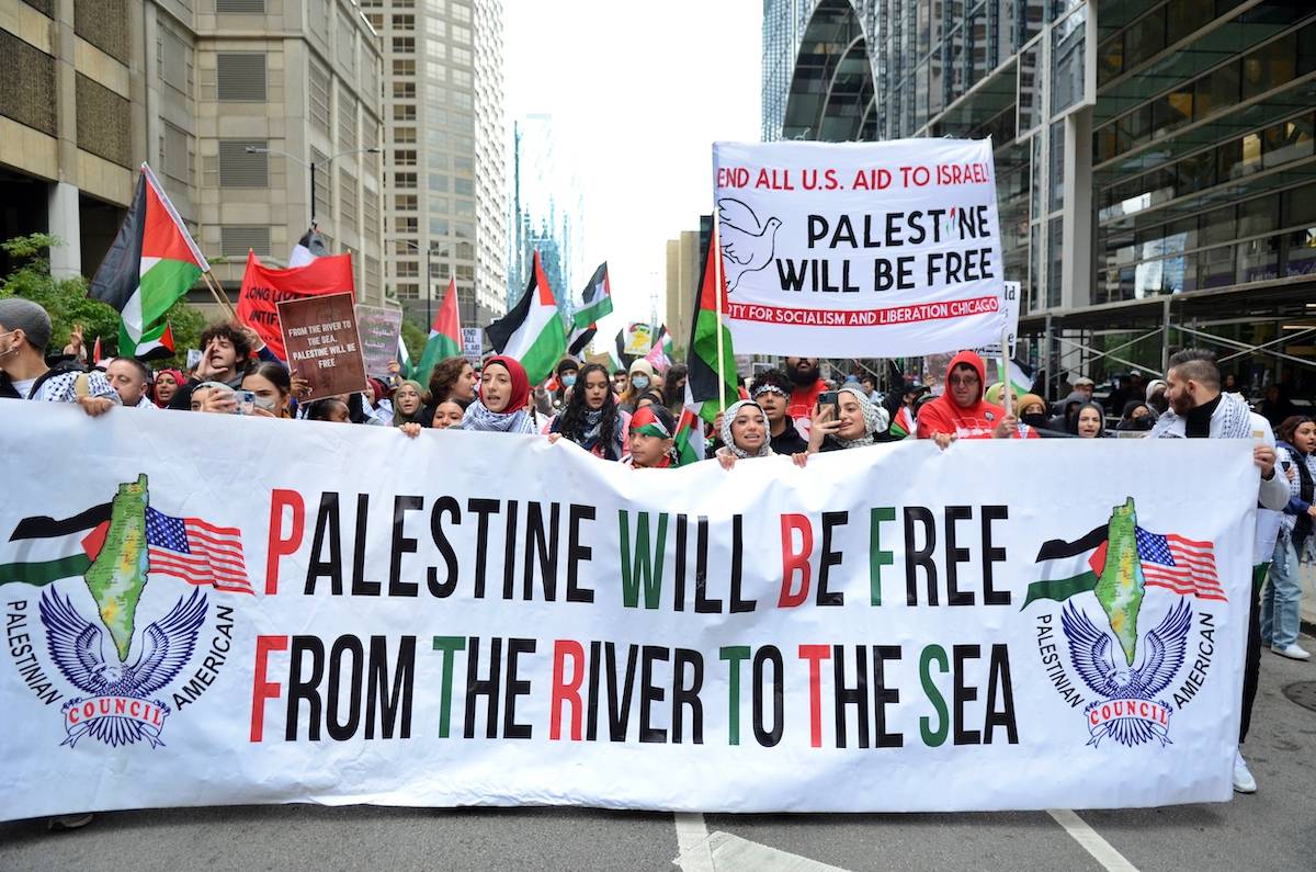 Palestinian protesters march through the streets of Chicago from Israeli consulate in Chicago during a protest organized by Chicago Coalition for Justice as the Israel-Hamas conflict continues on October 8, 2023, in Chicago, Illinois, United States. [Jacek Boczarski - Anadolu Agency]