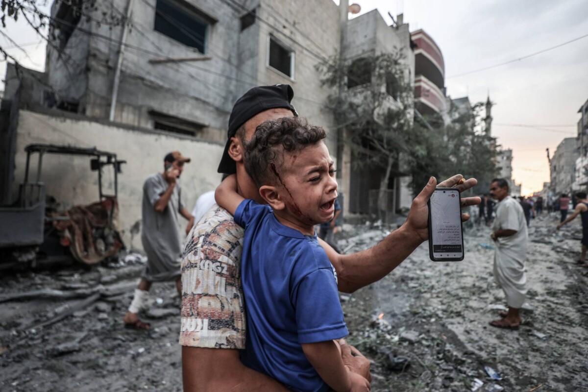 An injured Palestinian kid is seen after Israeli airstrikes at al-Shati refugee camp in Gaza Strip on October 09, 2023 [Ali Jadallah/Anadolu Agency]