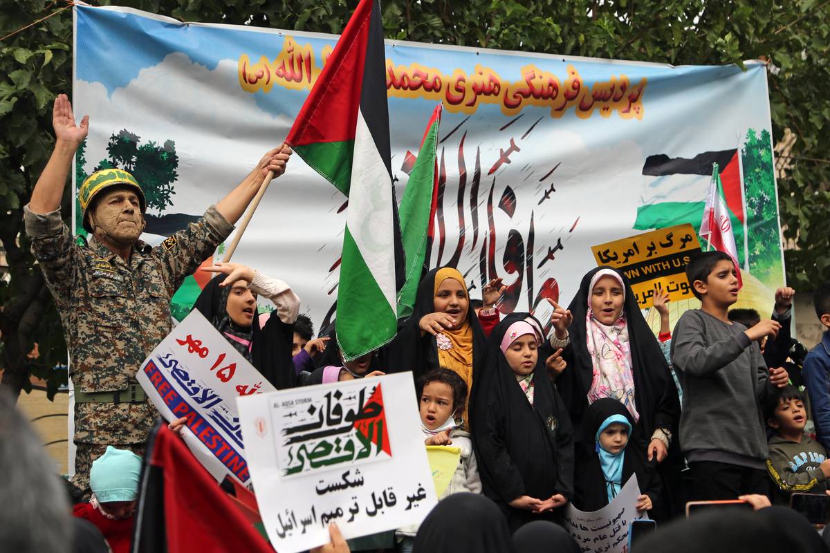 People attend the Pro-Palestine demonstration as they hold banners and flags at the Revolution street in Tehran on October 13, 2023 [Fatemeh Bahrami/Anadolu Agency]