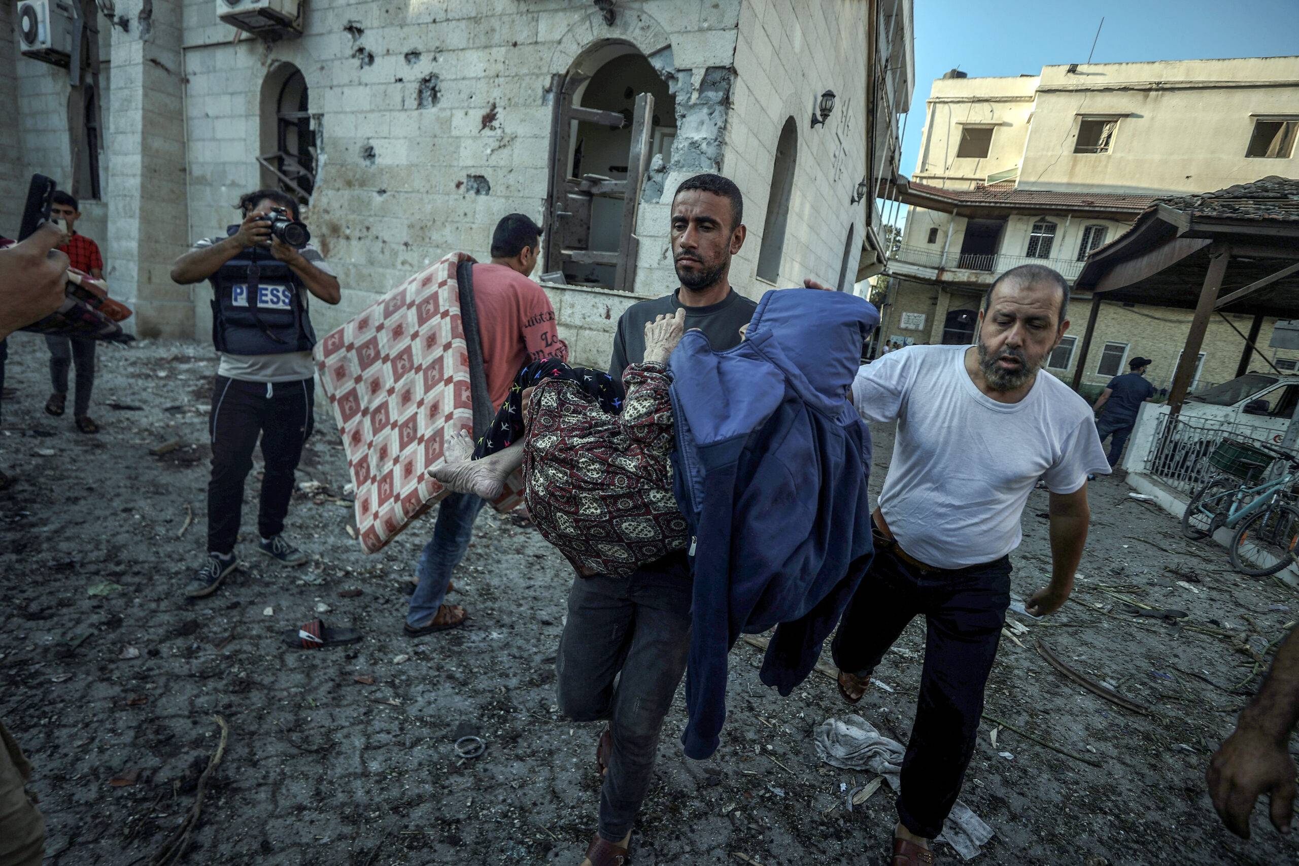 An injured Palestinian is carried away from Al-Ahli Baptist Hospital after it was hit in Gaza City, Gaza on October 18, 2023 [Ali Jadallah - Anadolu Agency]