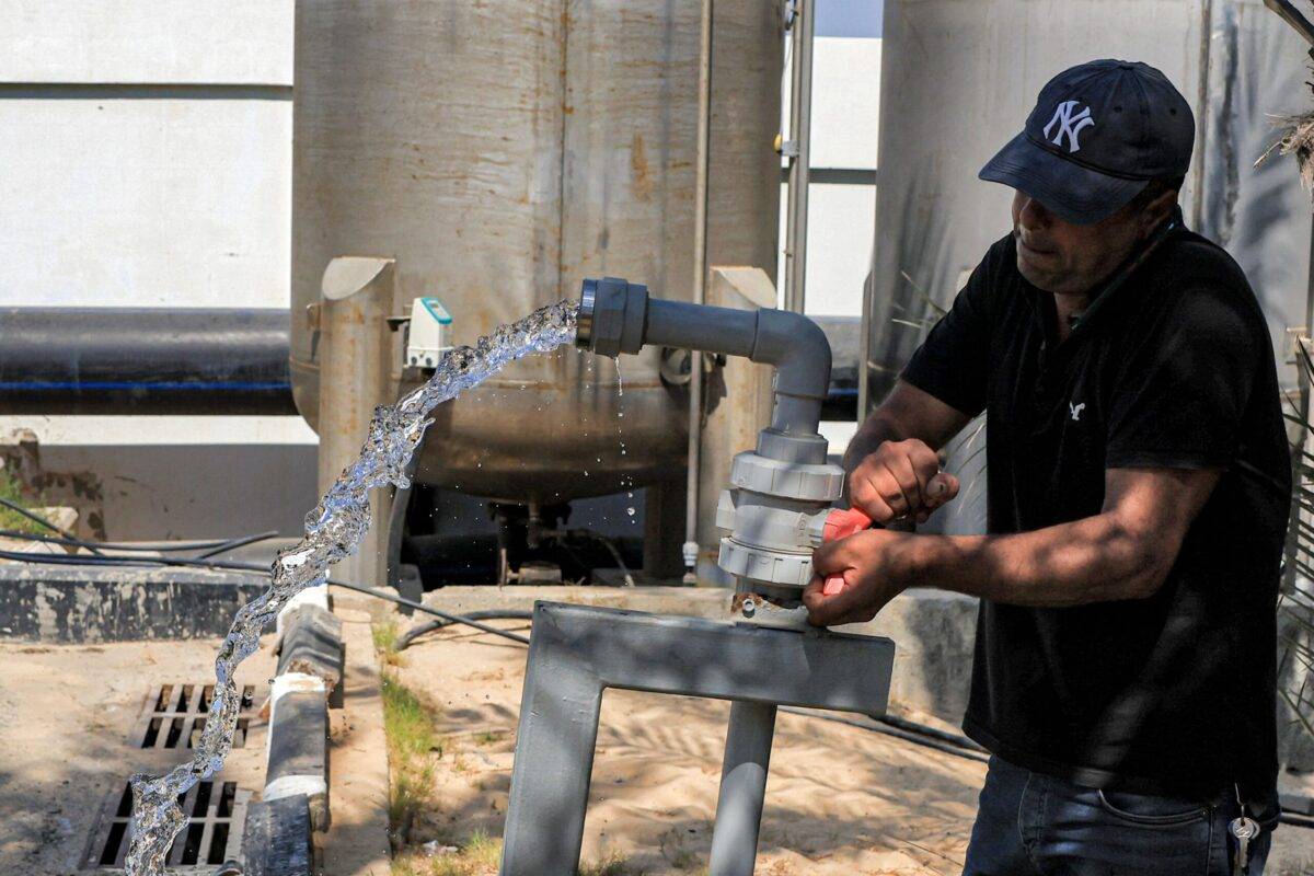 A Palestinian worker checks a valve at a water treatment station in Deir al-Balah in the central Gaza Strip on August 28, 2023 [MAHMUD HAMS/AFP via Getty Images]