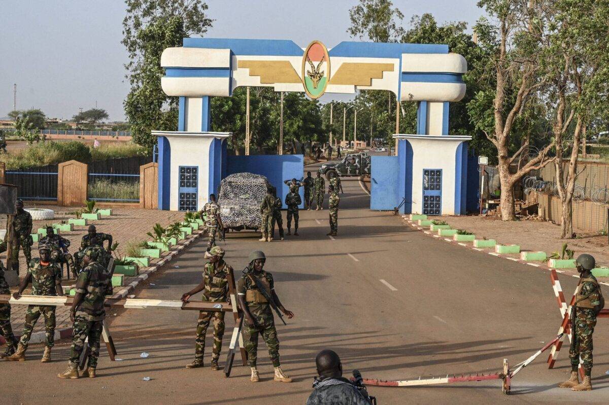 Soldiers stand guard as supporters of Niger's National Council of Safeguard of the Homeland (CNSP) protest ouside the Niger and French airbase, in Niamey on September 16, 2023 [AFP via Getty Images]