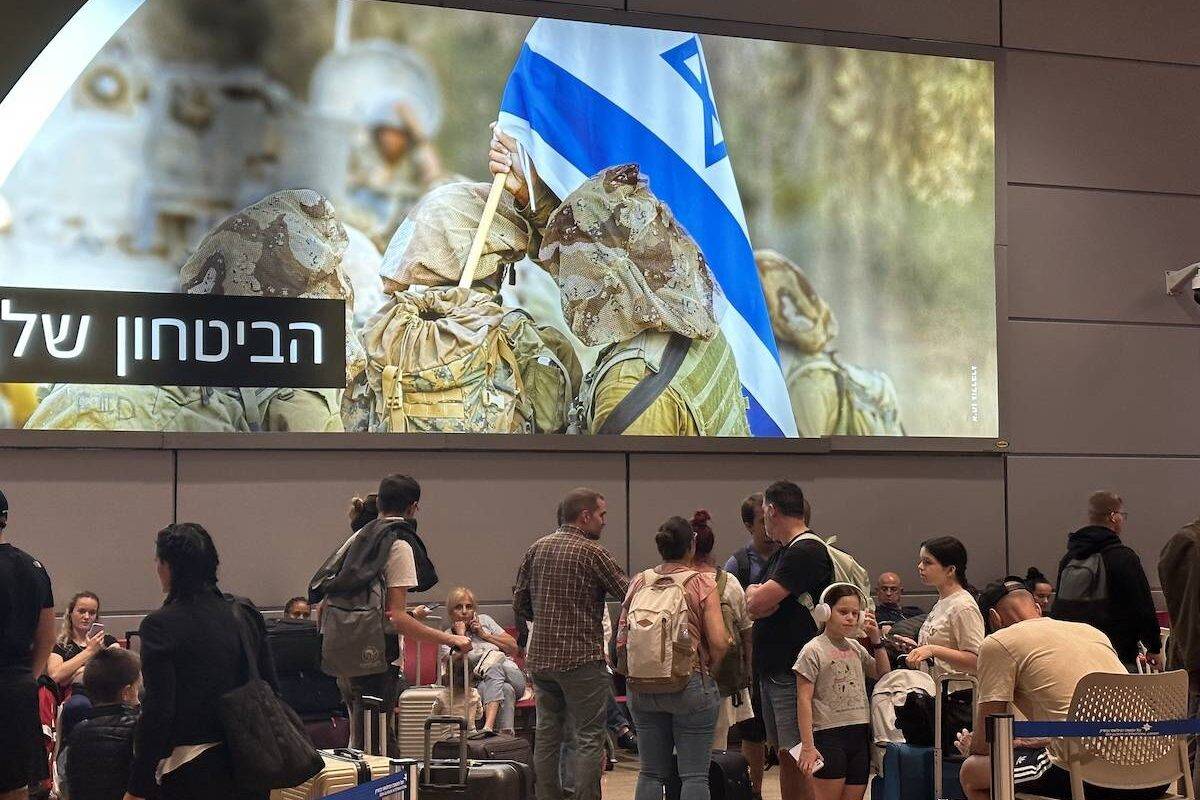 People wait in departing section at Ben Gurion Airport, Israel's only international airport, after many flights from abroad are cancelled due to the attacks launched by Palestinian factions in Tel Aviv, Israel on October 8, 2023. [Turgut Alp Boyraz/Anadolu Agency via Getty Images]