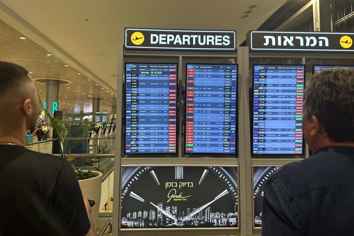 People look at the board showing departure schedules at Ben Gurion Airport, Israel's only international airport, after many flights from abroad are cancelled Palestinian factions in Tel Aviv, Israel on October 8, 2023 [Turgut Alp Boyraz/Anadolu Agency]