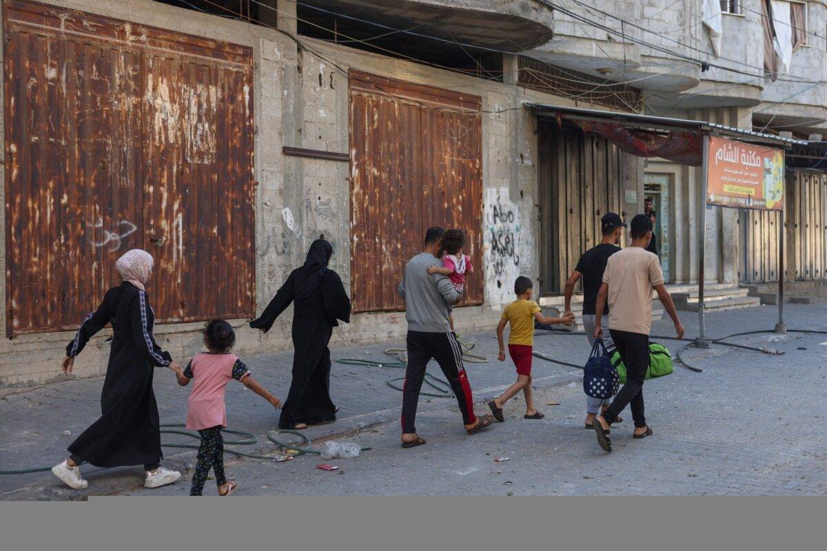 Palestinians carry belongings as they leave their home to a safer place after an Israeli airstrike in Rafah in the southern Gaza Strip on October 18, 2023 [MOHAMMED ABED/AFP via Getty Images]