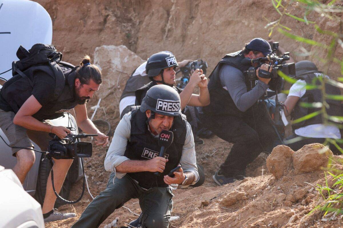 Reporters take cover upon hearing sirens warning of an incoming rocket attack from Gaza, in the southern Israeli city of Sderot, on October 23, 2023 [JACK GUEZ/AFP via Getty Images]